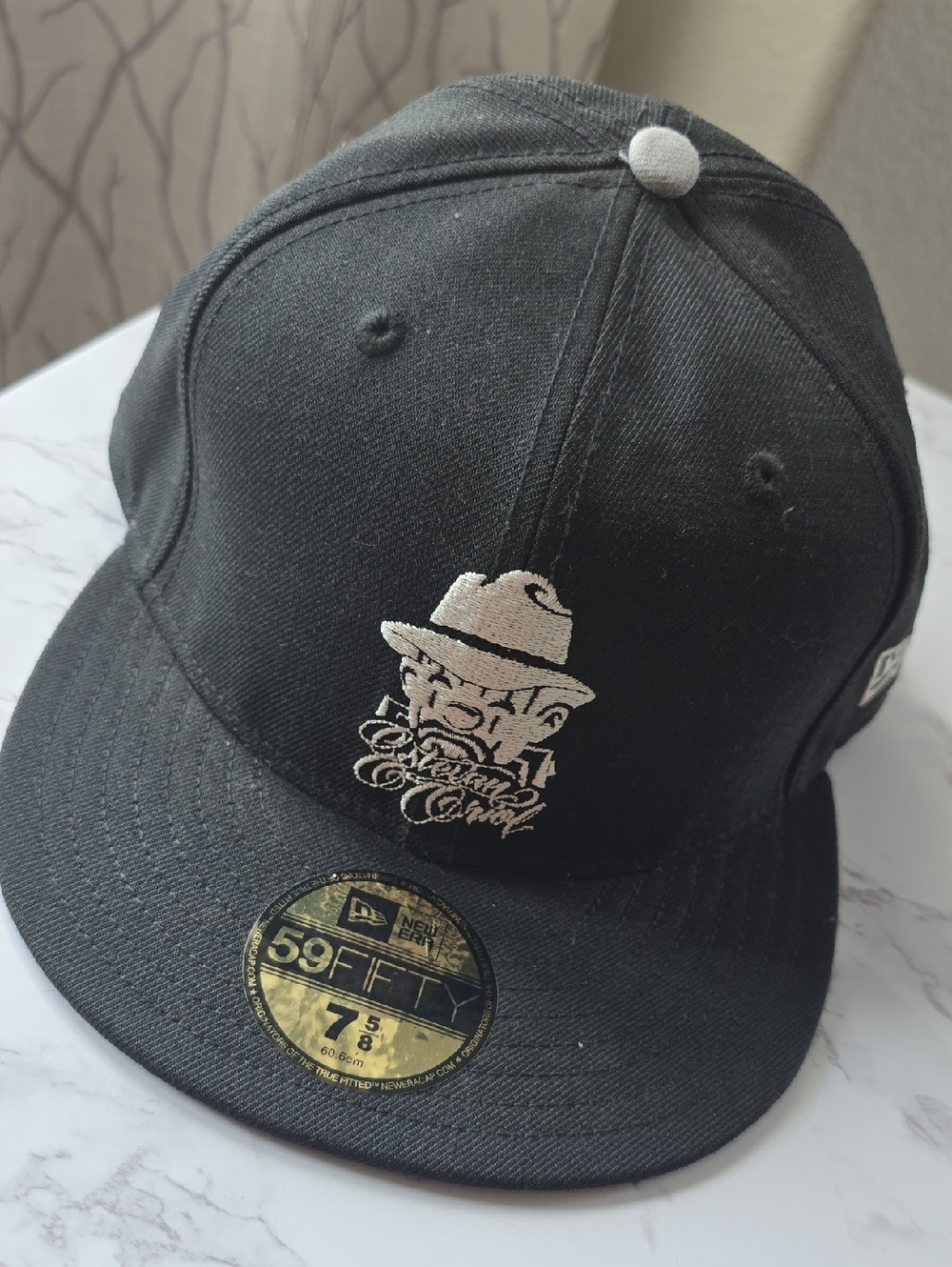 New Era Black Cap with Ivory Embroidered Character